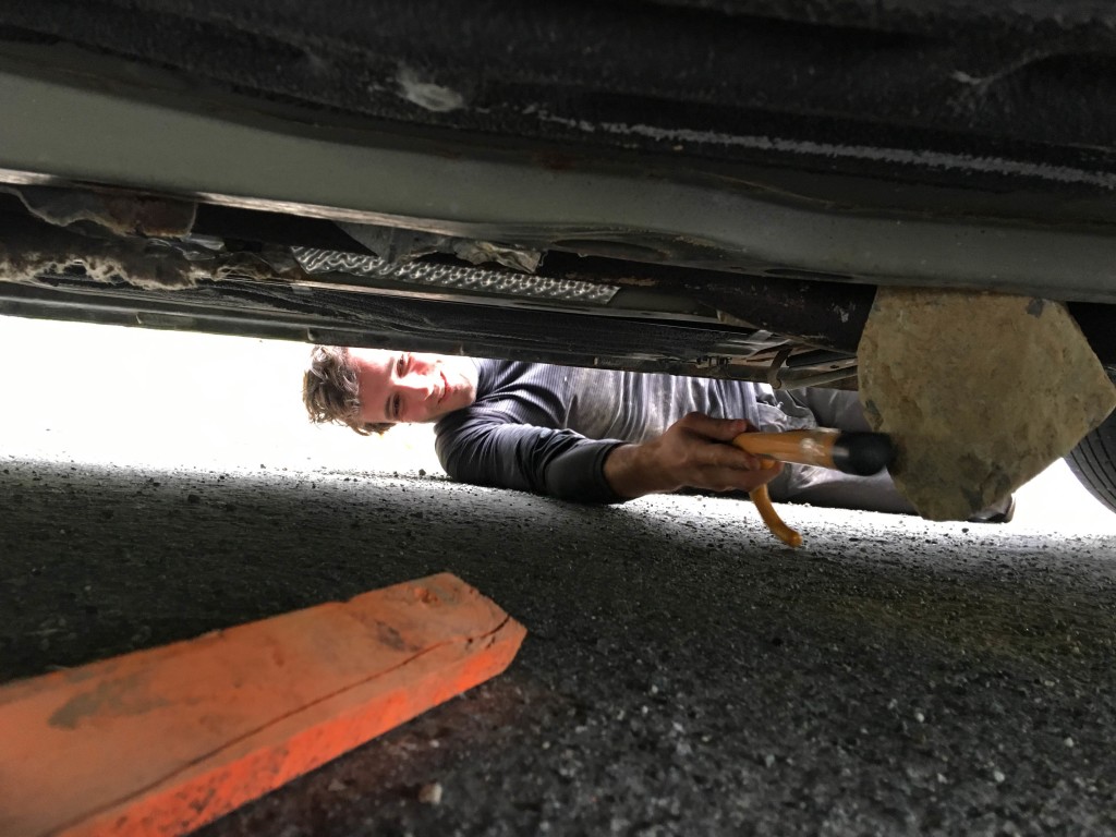 Luca inspecting the rock underneath his car.