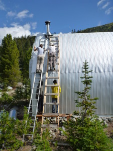 Siding slowly goes up on the hut.  Photo: Roland Burton