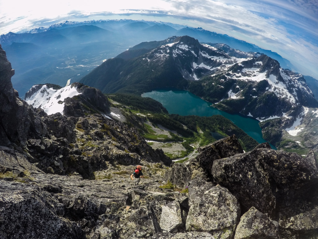 Kevin scrambling with beautiful views of Lake Lovely Water in behind. Photo: Matteo Agnoloni