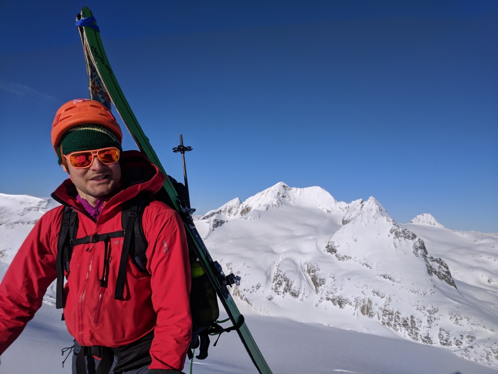 Olek on the summit of Eureka with Mount Weart in the background.