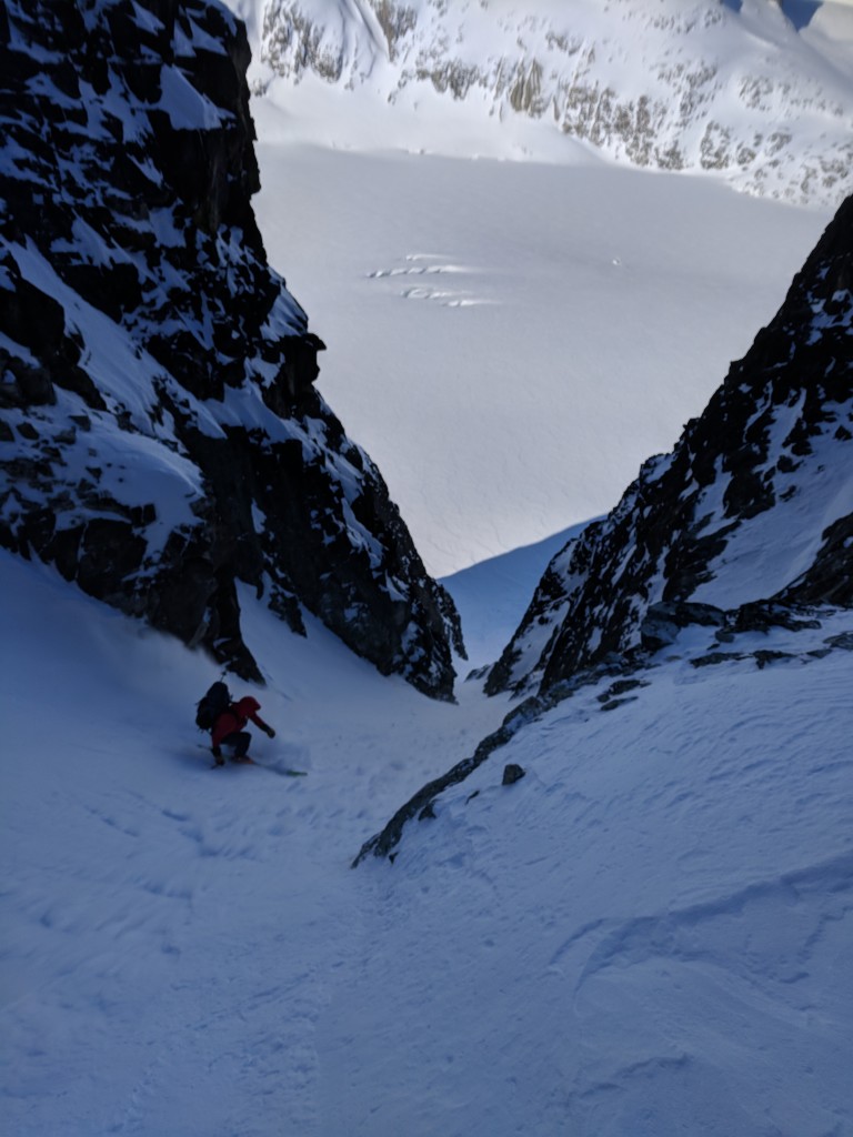 Olek skiing down the Eureka NW couloir with the Weart Glacier in the background.