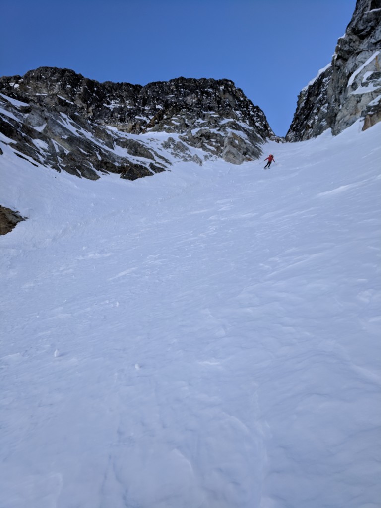 Nick opening up his turns as the couloir widens.