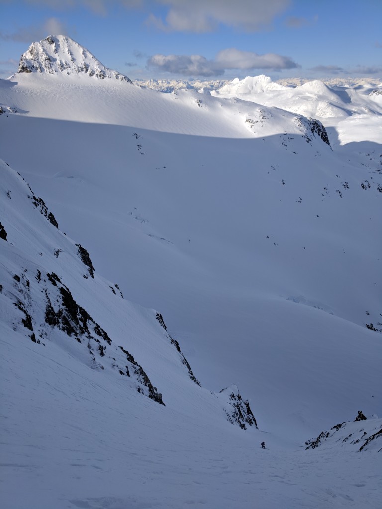 Olek nears the bottom of the couloir with Mount Moe in the background.