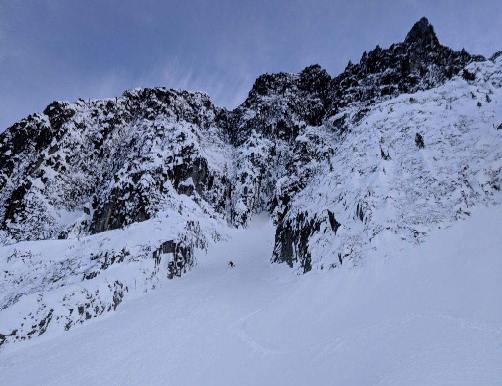 Olek exiting the final couloir of the trip. The Mordor-like, jagged sub-summits of Currie in the background.