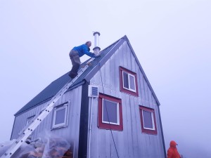 Cassandra slowly making her way on to the roof to fix the chimney cap. 