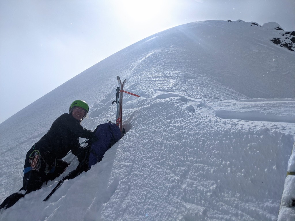 Birgit hiding from the wind at the top of the little couloir.