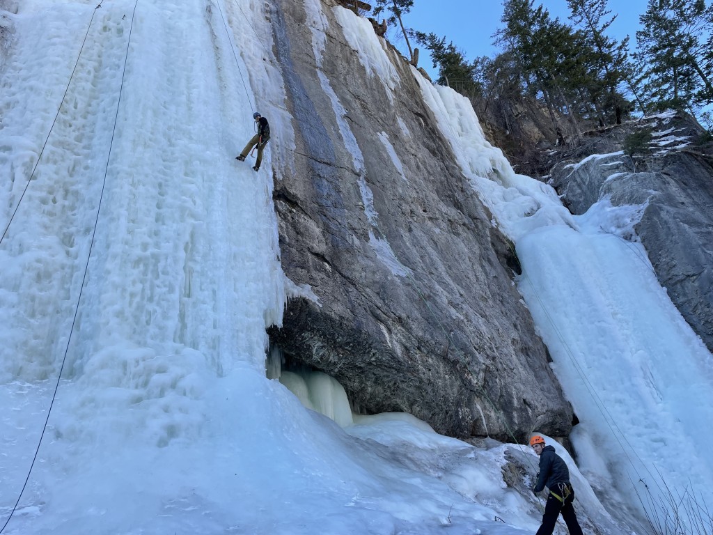 Fiona climbing some ice, belayed by Will. By Roan