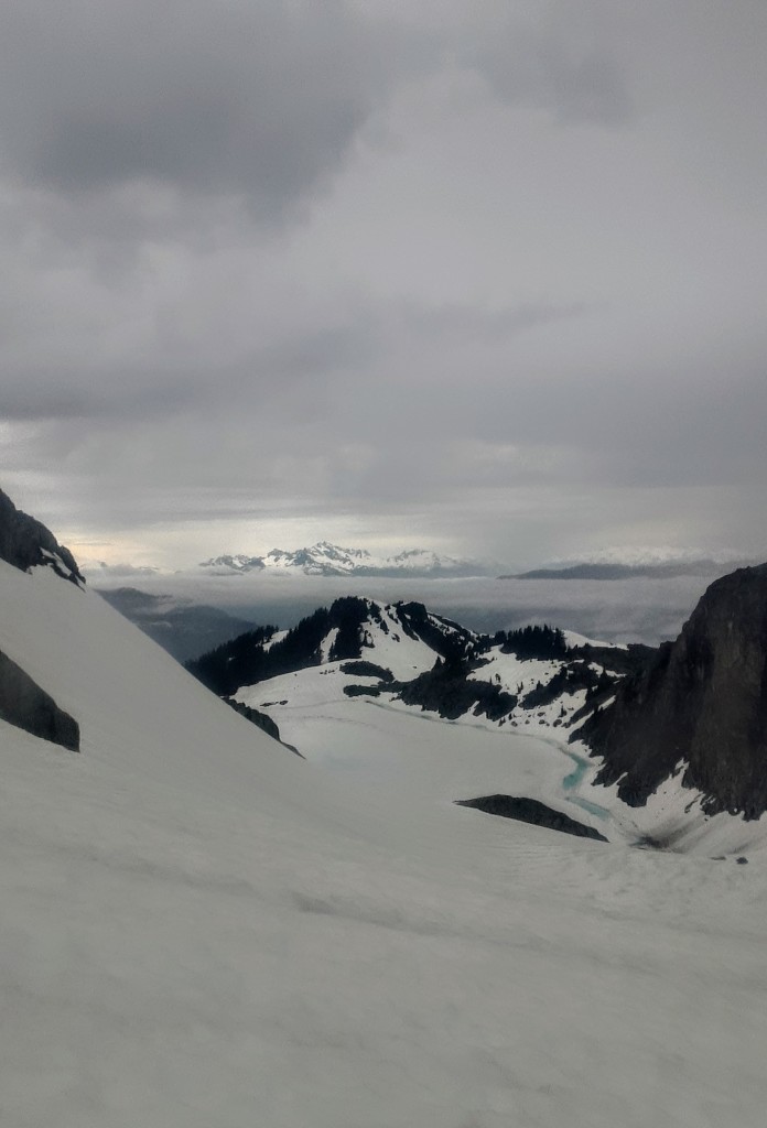 Mt Tantalus behind Knothole Lake, illuminated by a distant cloudbreak