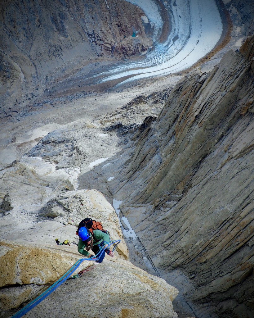 Swatting the rope at the crux. NB Photo.