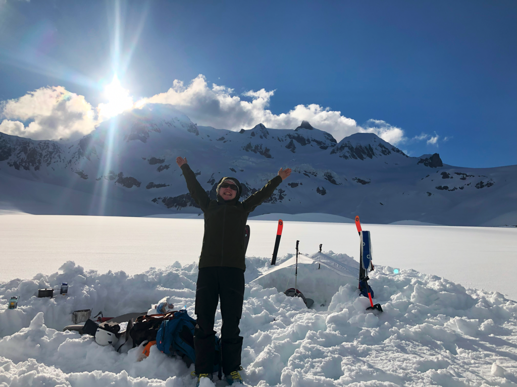 Flavia showing her excitement that camp is all set up and the sun is shining with the epic east face of the Nch’kay massif behind her. All that’s left to do is eat some Ukrainian borscht.