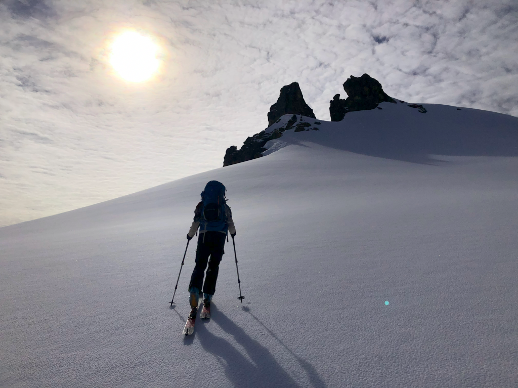 Flavia skinning up the still firm, sun-hidden northwest-facing slopes of The Gargoyles. While the southeast slopes made for a perfectly sun-softened, “corn-skiing” descent.