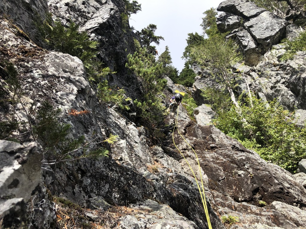 Errol reaching the bottom of our rappels, passing over many cliff bands.