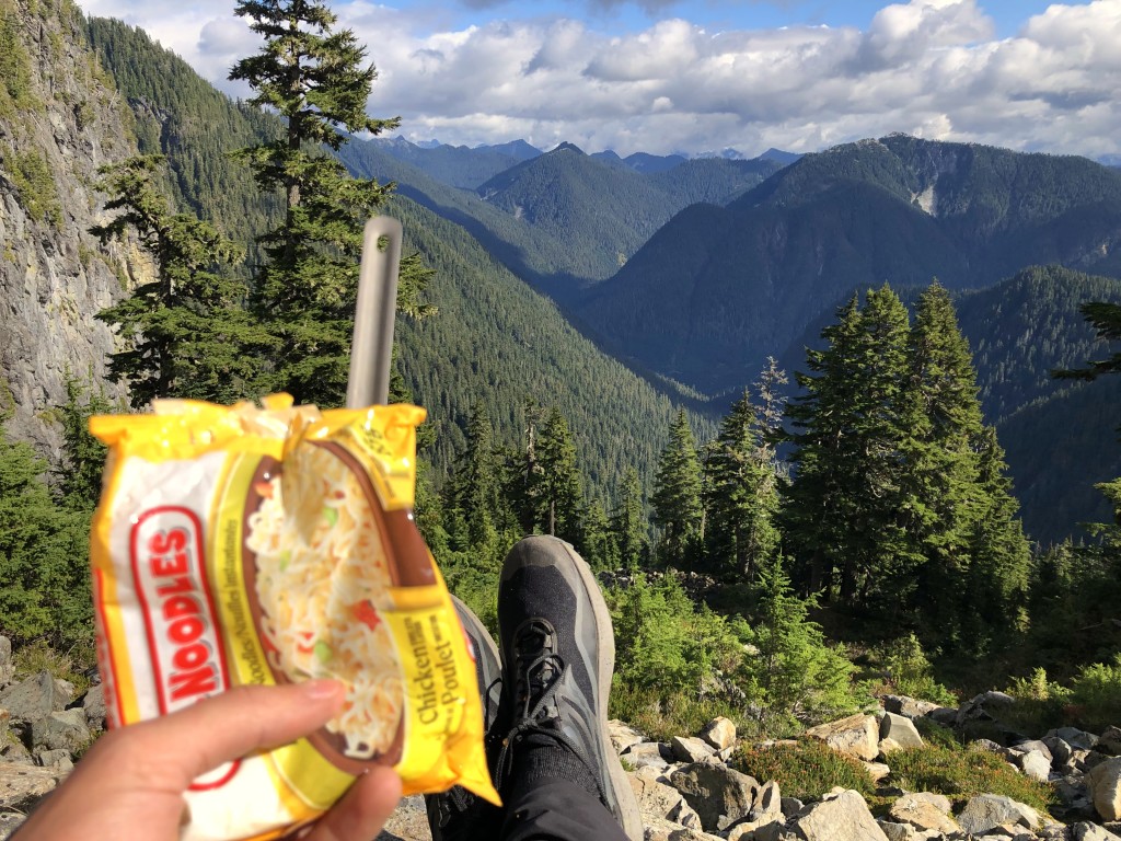 Looking east into the Capilano Water Shed and towards the obscure mountains of Appian Mountain and Drone Peak. Enjoying my favourite snack of raw ramen.