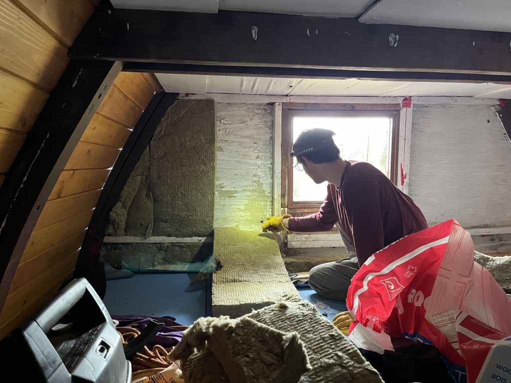 Jacob working on insulating the sleeping platform. PC: John Sherk