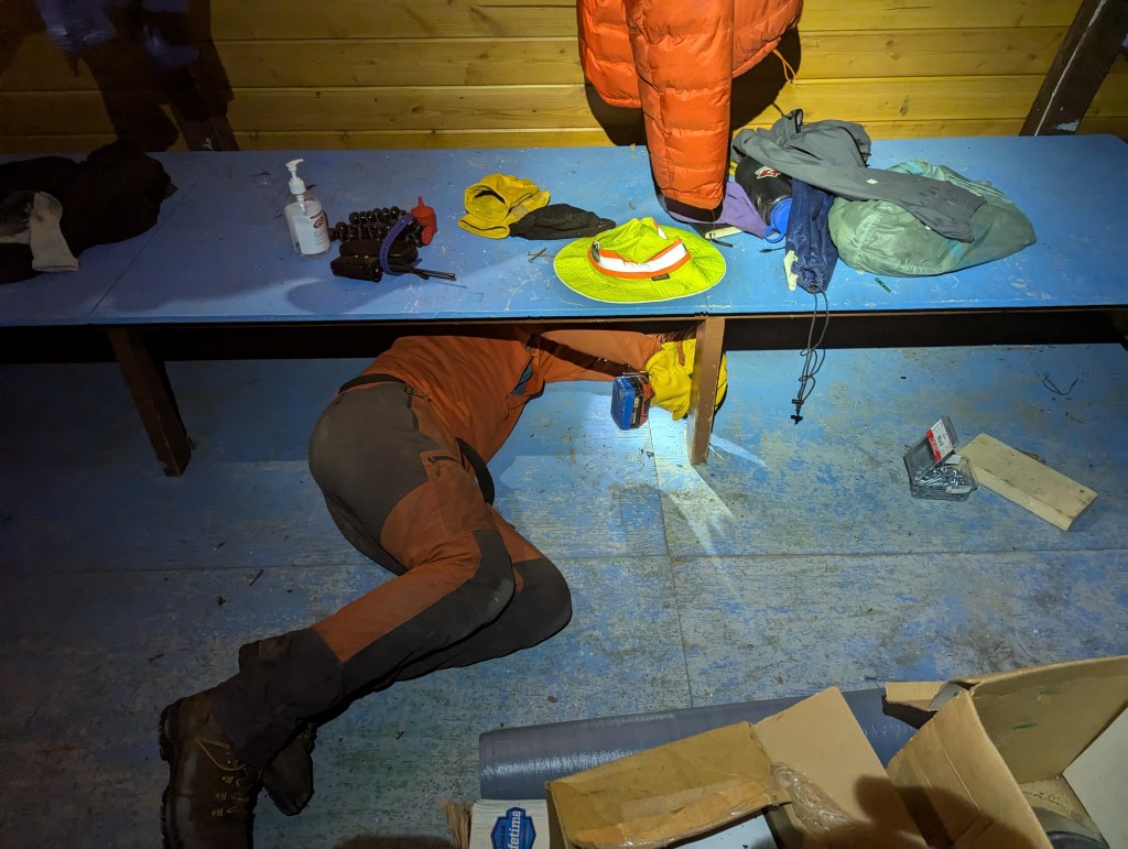 Attaching the bench to the floor. Next to me is the source of great frustration: the Robbie head screw. PC: Jacob Grossbard