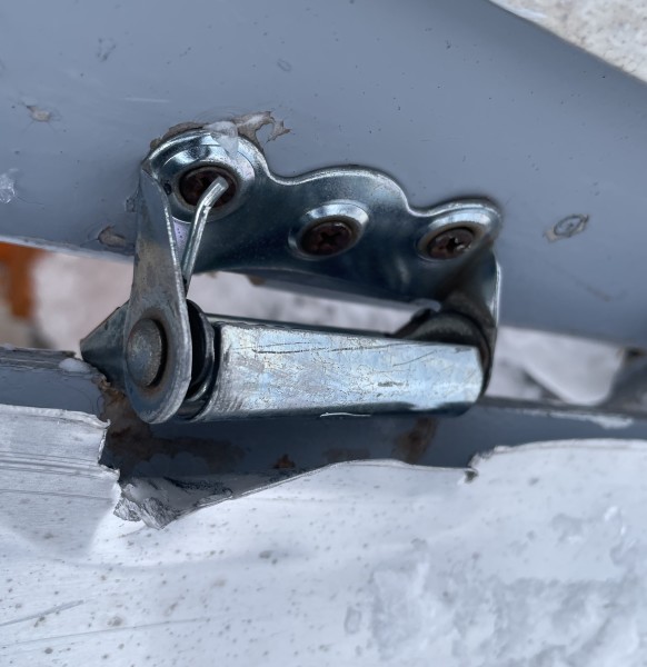 A bent hinge on the outhouse, soon to be removed. PC: Joseph Chiao