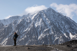 Lionel below the north face of Mount Maxwell rising 2000 metres above the glacier.