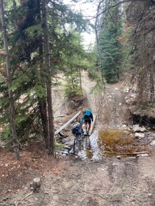 Me, pushing the bike through a washed portion of the road